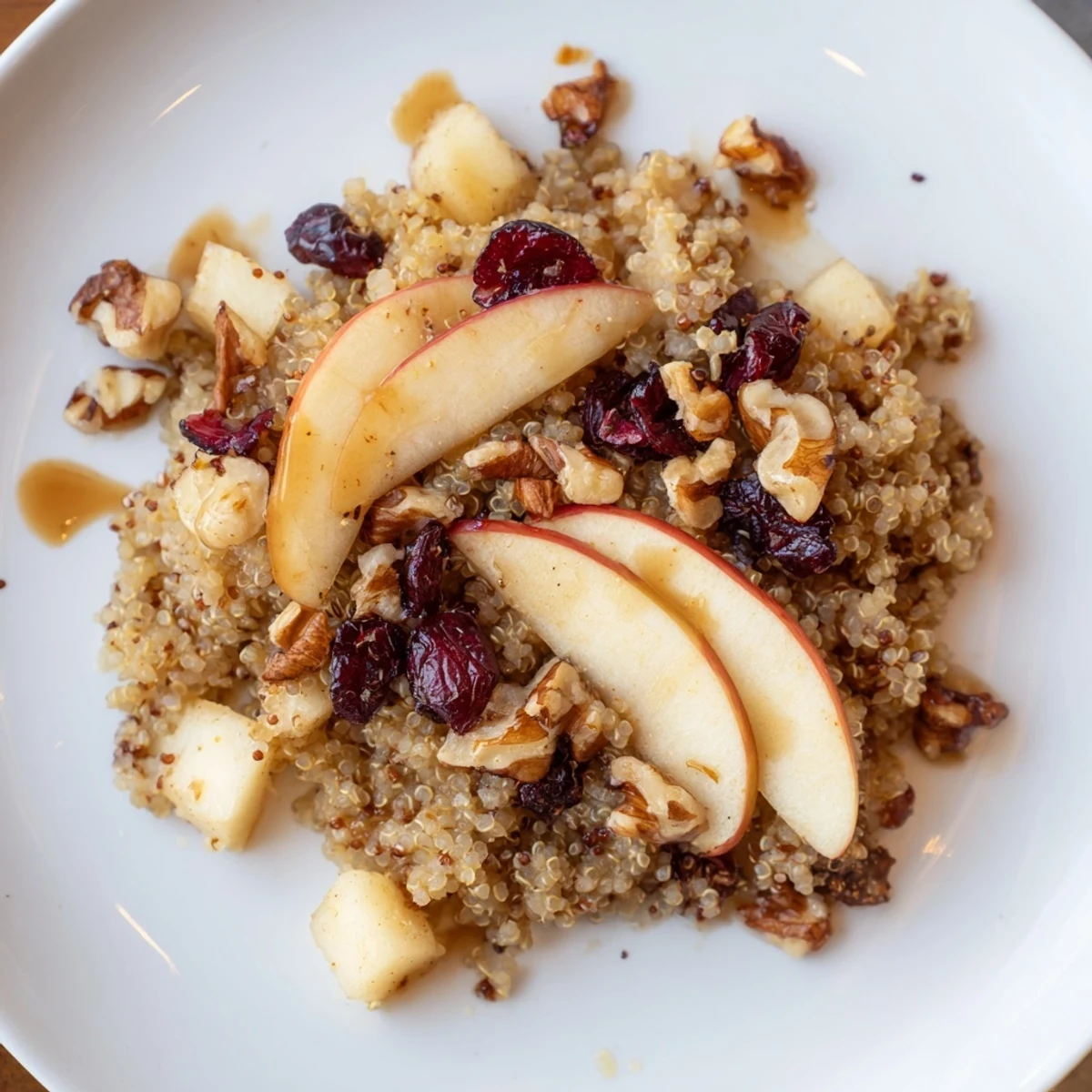 Steaming Apple Cinnamon Quinoa Bowl, a hearty breakfast with sweet apples and warming spices, ready to eat!