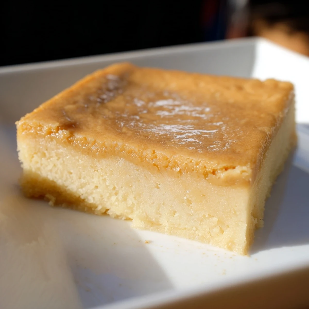 Golden-brown Peanut Butter Mochi Cake, a chewy dessert perfect with whipped cream and fruit.