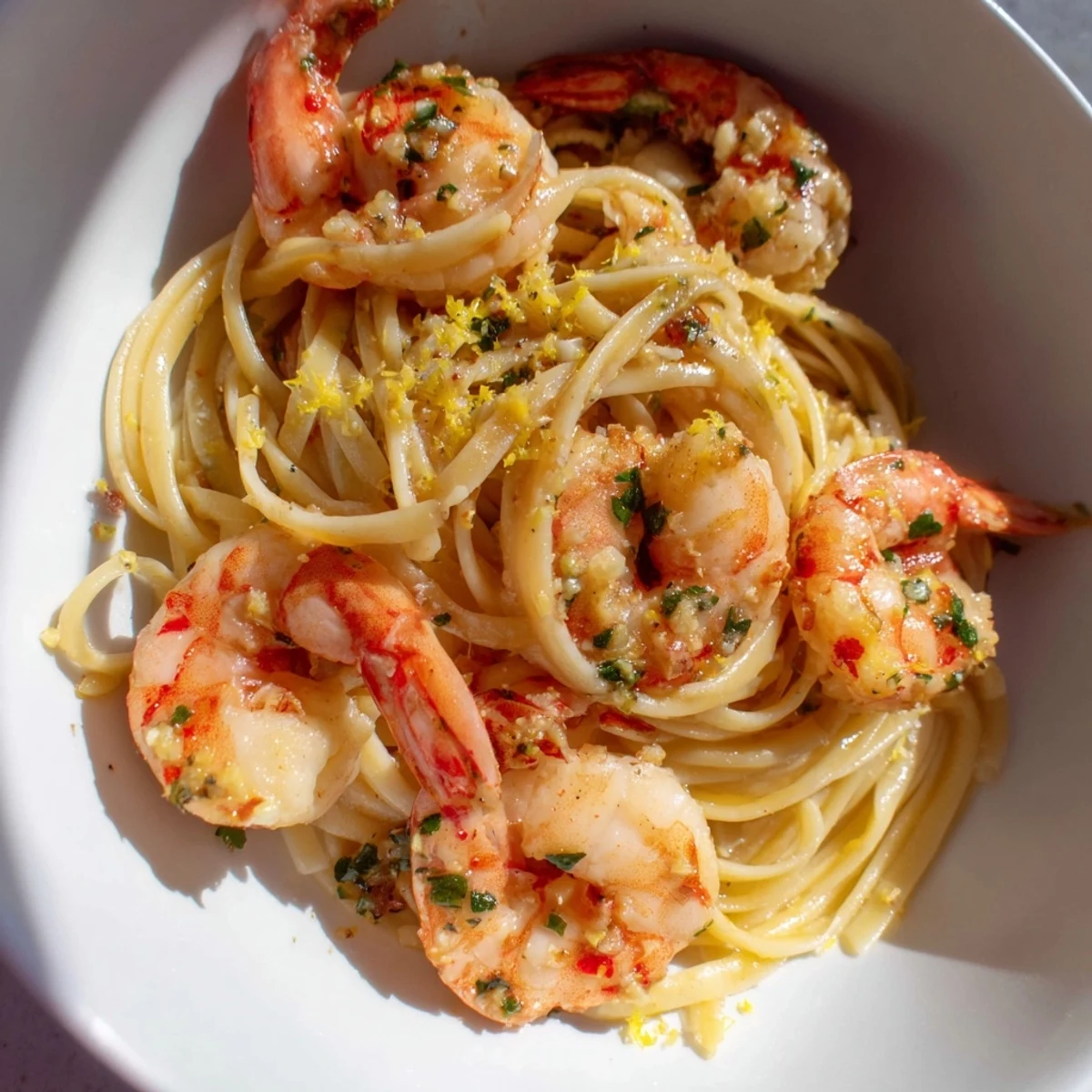 Bright, flavorful serving of Lemon Herb Pasta with Shrimp, garnished with fresh herbs and lemon wedges.