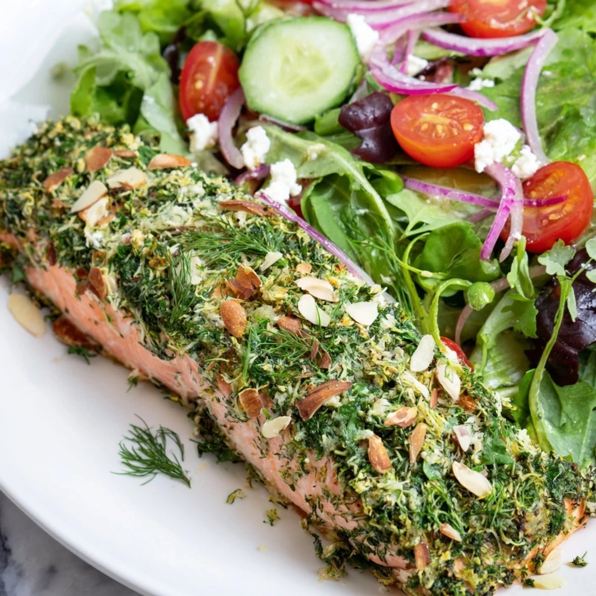 Perfectly cooked herb-crusted salmon nestled among fresh salad greens in this healthy meal.