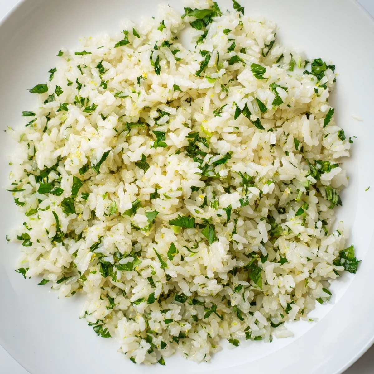 Steaming bowl of Cilantro Lime Rice, creamy, flavorful, perfect with your Mexican dinner.