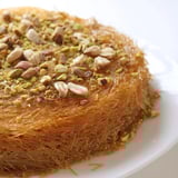 Warm, aromatic Egyptian Konafa dessert layered with nuts, baked to a delicious, golden perfection.