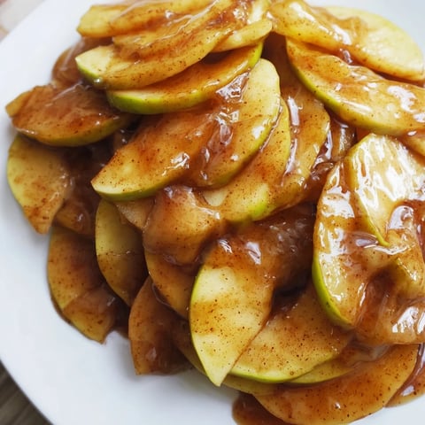 Warm, bubbling baked apple slices with cinnamon and brown sugar, a perfect easy dessert.