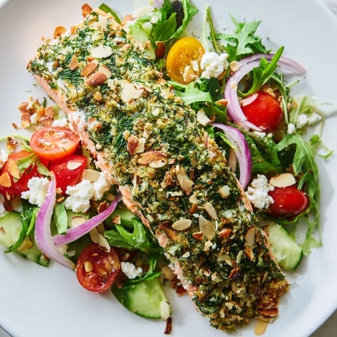 Warm, flaky herb-crusted salmon salad with bright cherry tomatoes and a tangy vinaigrette.