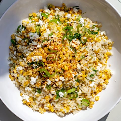 Mexican Street Corn Rice: A creamy, flavorful side dish dotted with charred corn and crumbled cotija cheese.