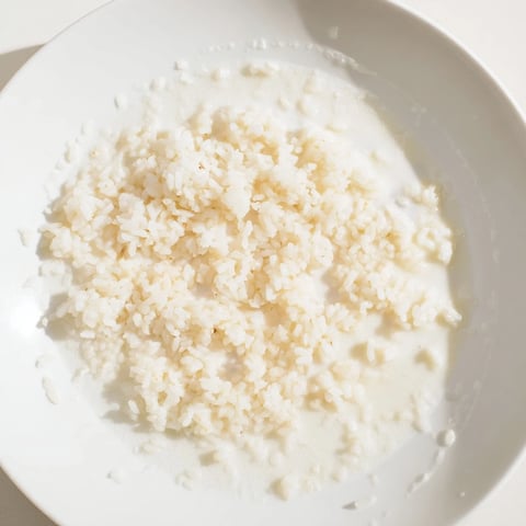 Fluffy Coconut Jasmine Rice, a creamy side dish, ready to savor with Thai green curry.