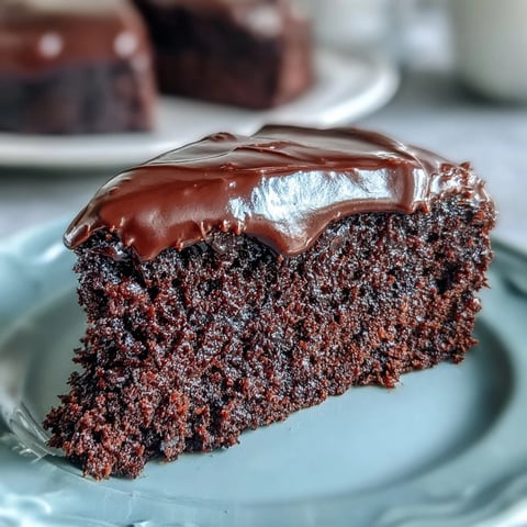 Easy Chocolate Fudge Cake recipe with a smooth, glossy chocolate icing and moist, crumbly cake layers.