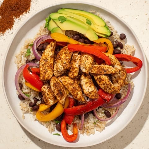Make-Ahead Chicken Fajita meal prep bowls, vibrant with sizzling chicken and colorful bell peppers, ready to eat.