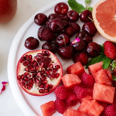 See the elegant Pomegranate Pivot, a refreshing fruit platter with layered red and pink fruits.
