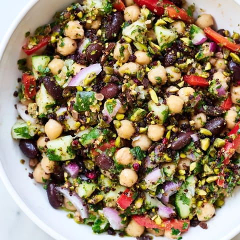 Freshly tossed Dense Bean Salad showcasing hearty beans and a sweet and savory chocolate flavor profile.