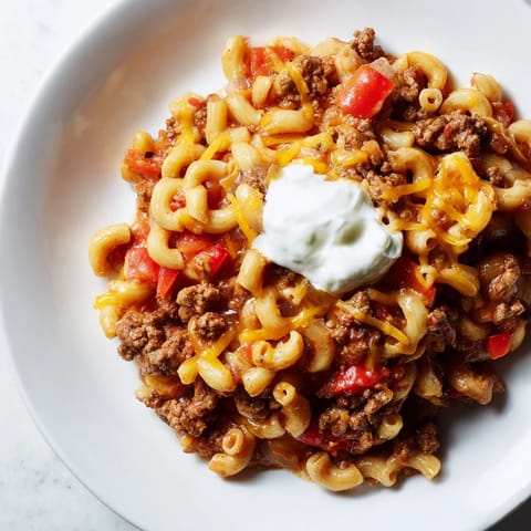 Creamy One-Pot Chili Mac topped with melted cheddar, perfect for a family-friendly, weeknight dinner.
