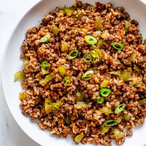 Golden brown Cajun Dirty Rice, perfectly seasoned and cooked with flavorful ground meats.