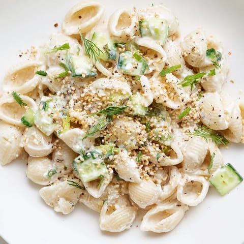 A bowl of chilled Cucumber Crunch Pasta Salad topped with everything bagel seasoning for a savory finish.  