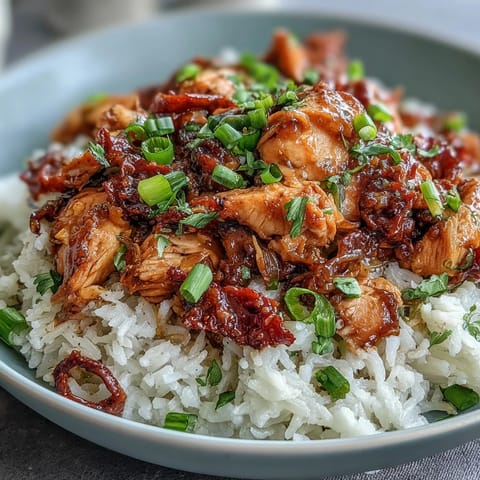 1. Crockpot Mississippi Chicken Rice Bowls with tender shredded chicken, zesty pepperoncini, and ranch-seasoned juices over fluffy rice.  
