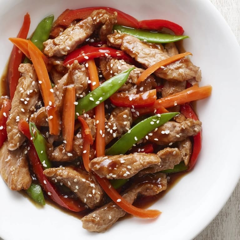 This Sweet Teriyaki Pork Stir-Fry showcases vibrant vegetables and tender pork coated in a rich, flavorful sauce.